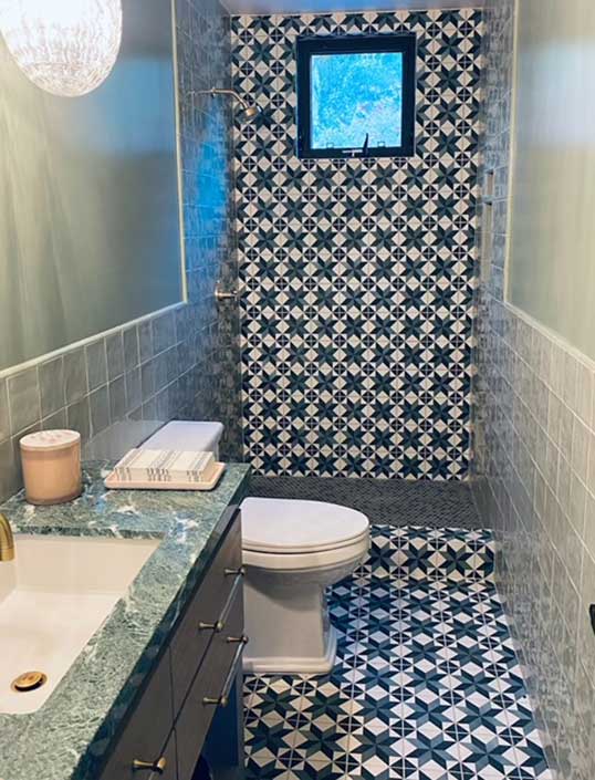 vibrant tile pattern on floor and wall with vanity